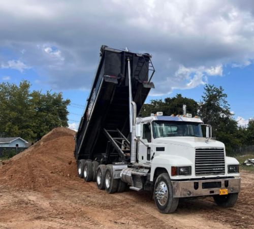 dump truck releasing fill dirt