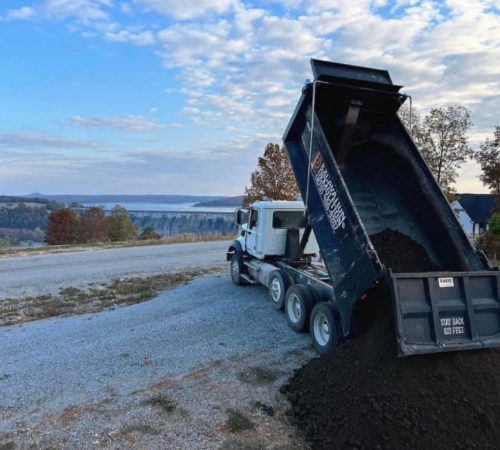 dump truck delivering top soil